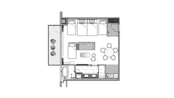 A floor plan of a hotel room with a bed, a desk, a chair, a small bathroom, and a dining area with a table and chairs.
