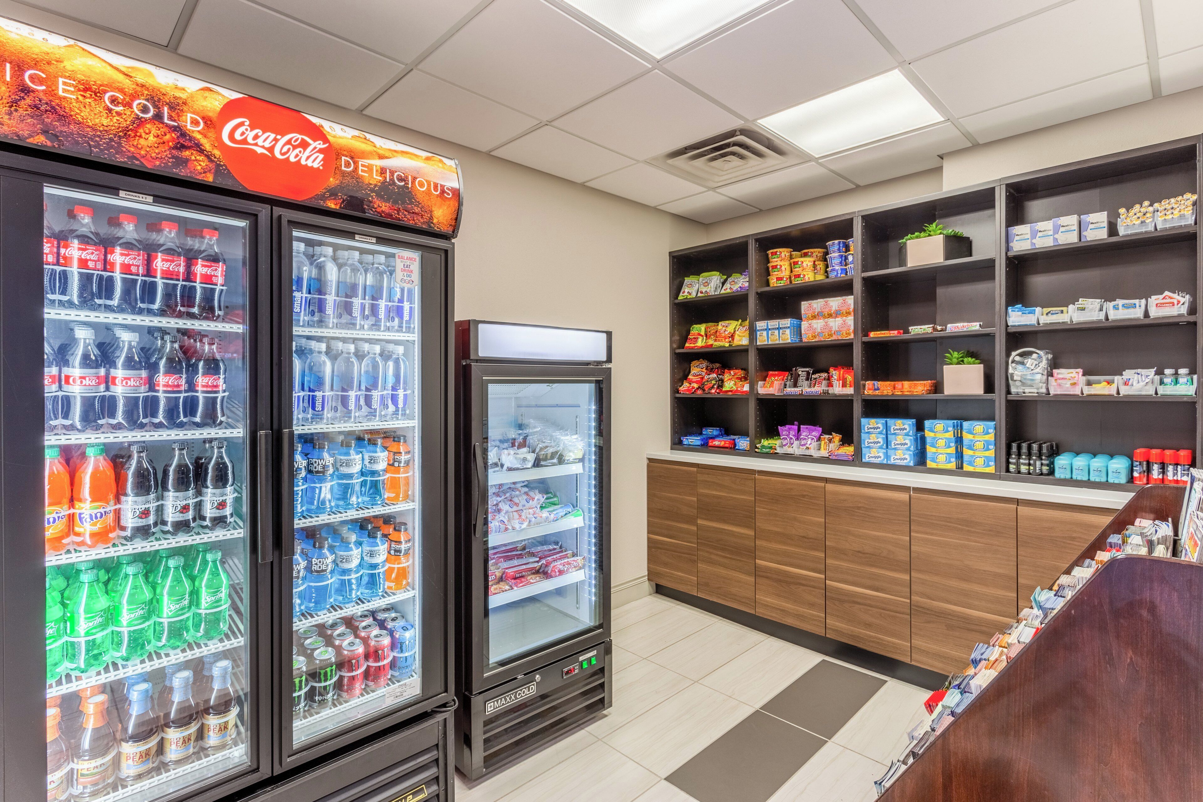 A vending area with various drinks and snacks, including Coca-Cola and Powerade.