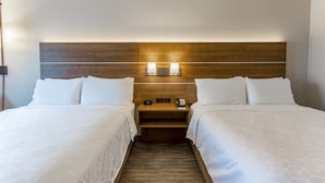 A hotel room with two beds, a wooden headboard, bedside lamps, a nightstand, and a carpeted floor. - Holiday Inn Express & Suites O'Fallon/Shiloh by IHG (O'Fallon)