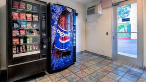 A vending machine with a Pepsi logo and a snack vending machine with various snacks. - Motel 6 Chino, CA - Los Angeles Ontario (Chino)