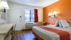 A hotel room with a bed, desk, chair, and a window with curtains. - Motel 6 Mesa, AZ - South (Mesa)