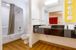 A modern bathroom with a bathtub, toilet, and sink. - Motel 6 Mesa, AZ - South (Mesa)