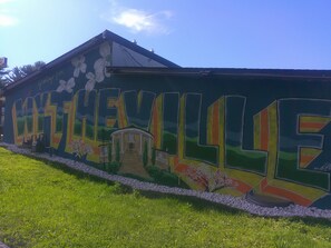 A building with a mural of the word "LITTLEVILLE" and a depiction of a house with a porch. - Red Roof Inn Wytheville (Wytheville)