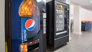 A vending machine with a Pepsi logo and a black vending machine with various snacks. - Motel 6 Williams, AZ - West - Grand Canyon (Williams)