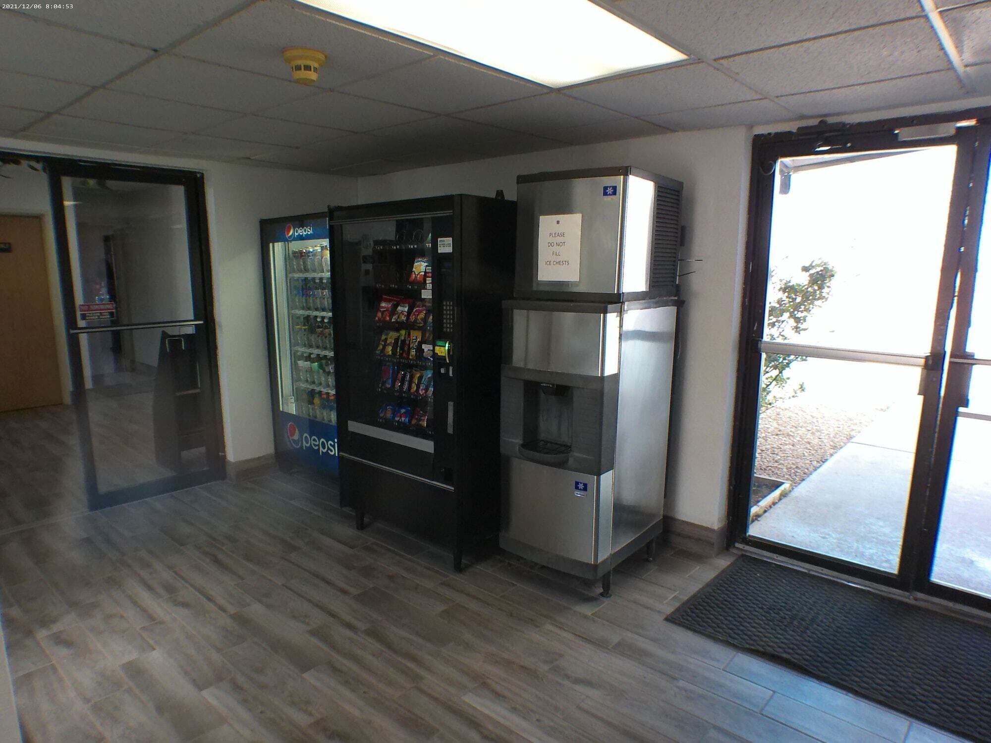 A vending machine area with a Pepsi refrigerator and a water dispenser.
