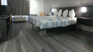A modern hotel room with a large bed, a desk, and a chair. - Motel 6 Winslow, AZ (Winslow)