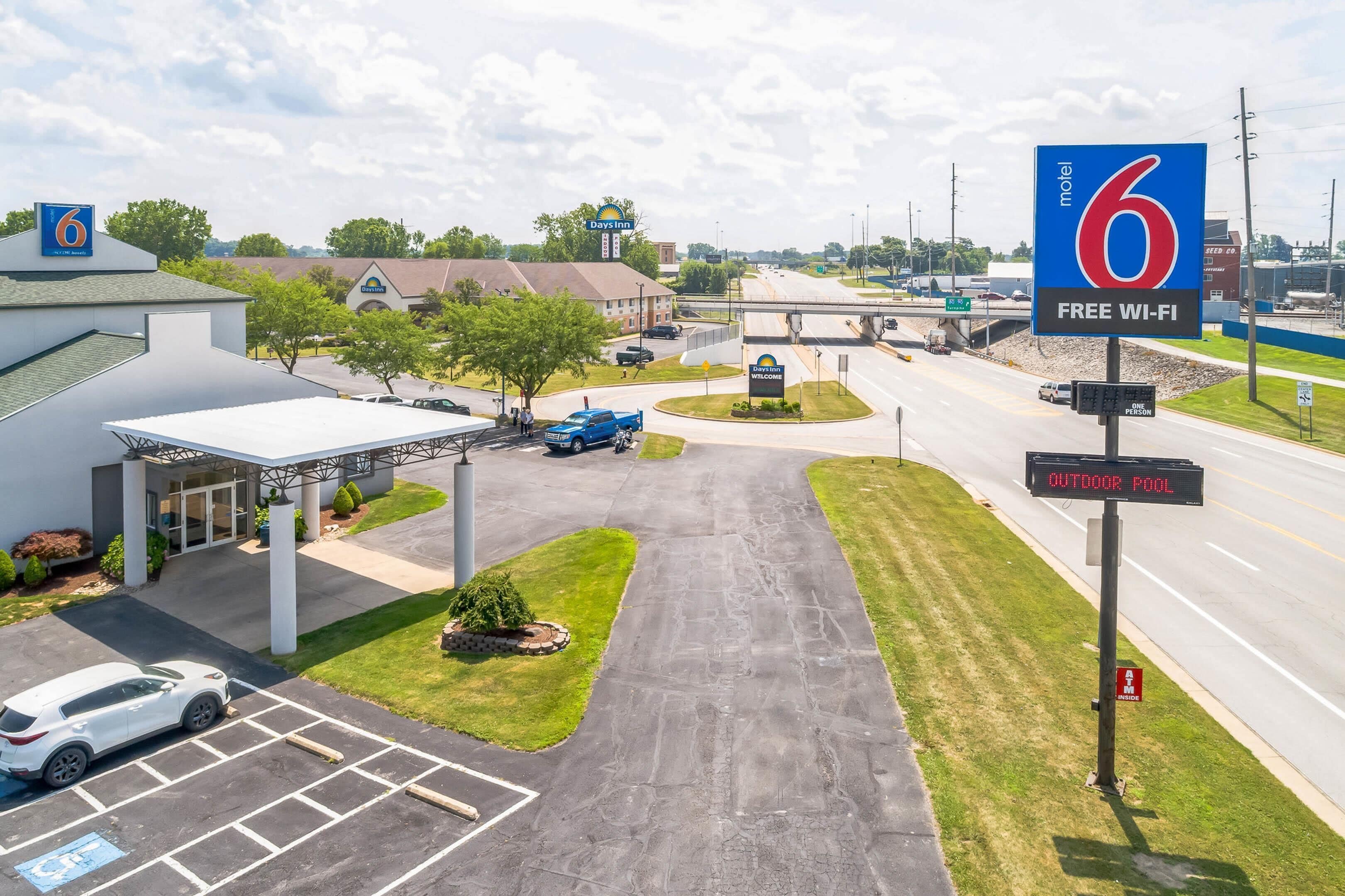 A motel with a sign indicating free Wi-Fi and an outdoor pool.