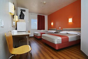 A hotel room with a desk, two beds, a chair, and a window with curtains. - Motel 6 Benson, AZ (Benson)