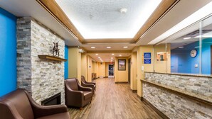 A hotel lobby with a stone wall, a reception desk, and leather chairs. - Days Inn by Wyndham Vernal (Vernal)