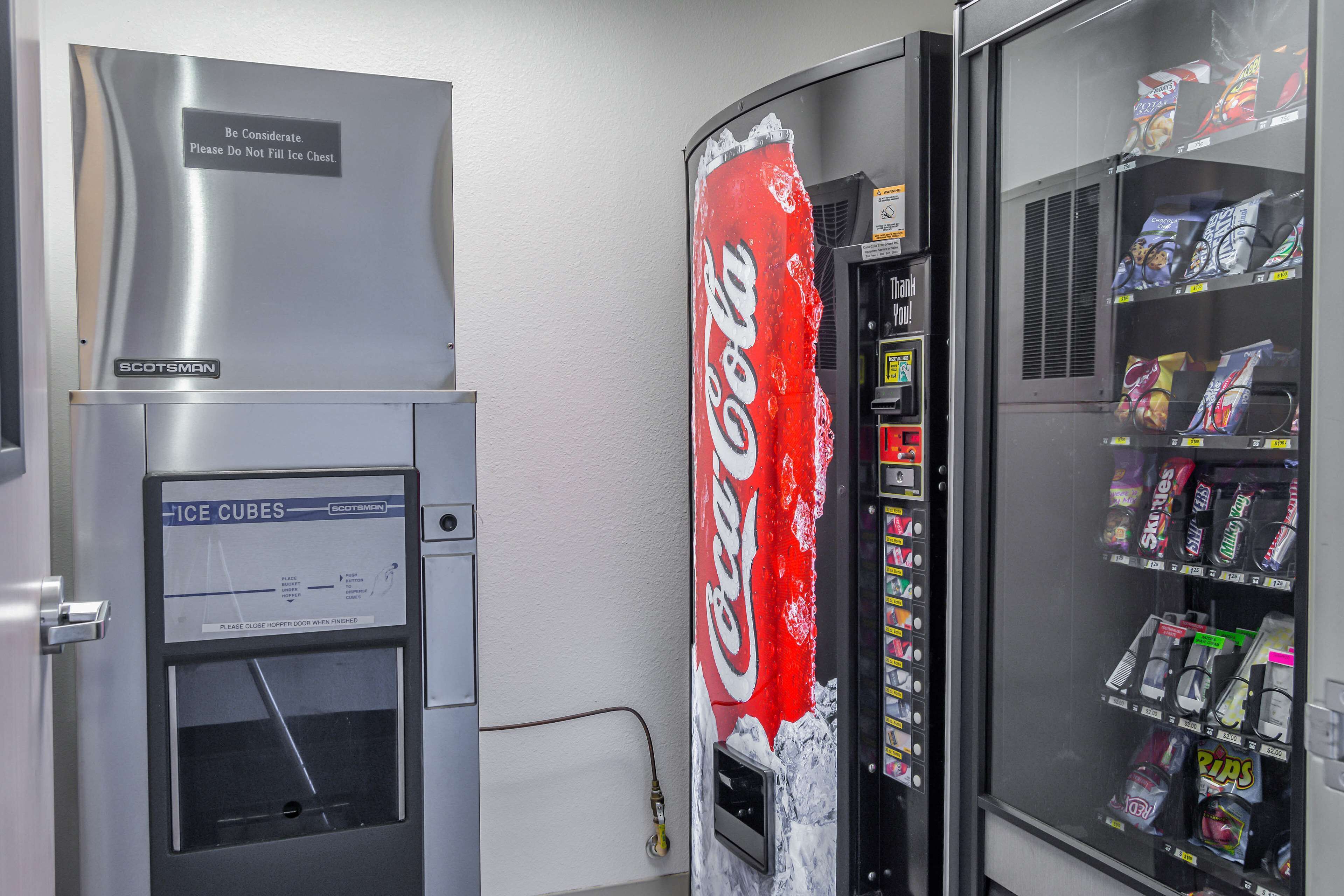 A vending machine with a Coca-Cola logo and a freezer compartment.