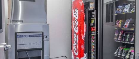 A vending machine with a Coca-Cola logo and a freezer compartment.