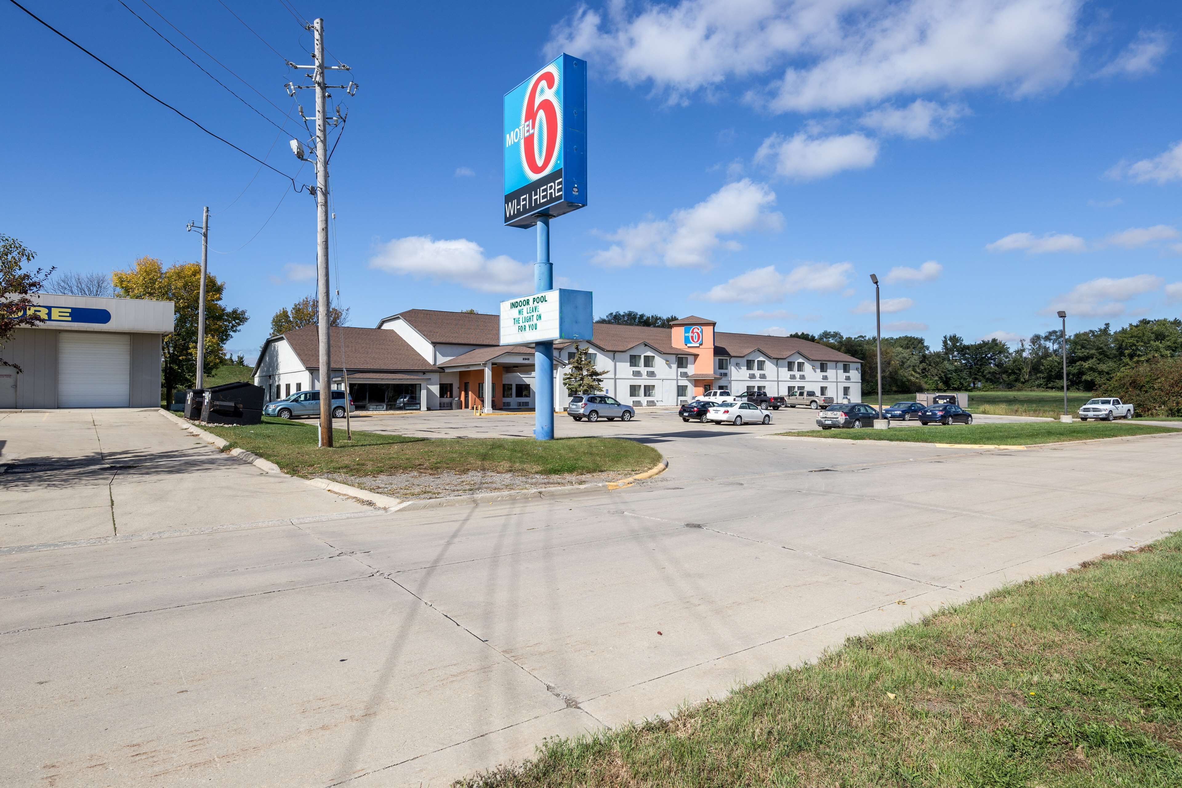 A motel with a sign indicating indoor pool and Wi-Fi availability.