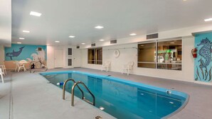 An indoor swimming pool with a blue water feature, white walls, and a mural of sea creatures. - Econo Lodge Belle Fourche (Belle Fourche)