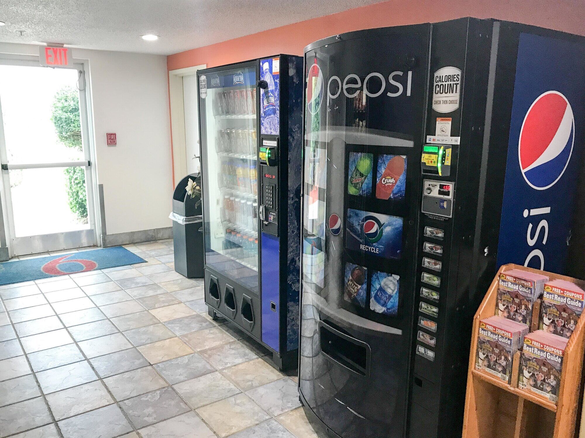 A vending machine area with a Pepsi machine and a water dispenser.