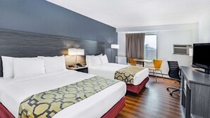 A hotel room with two beds, a desk, a chair, a TV, and a window with curtains. - Baymont by Wyndham Gillette (Gillette)