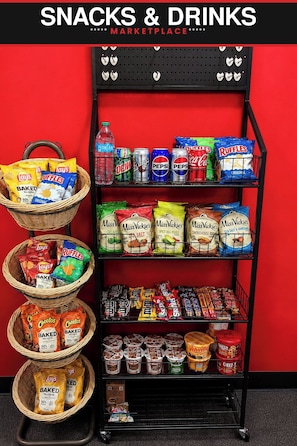 A snack and drink display in a marketplace with various snacks, chips, and beverages. - Econo Lodge Menomonie (Menomonie)