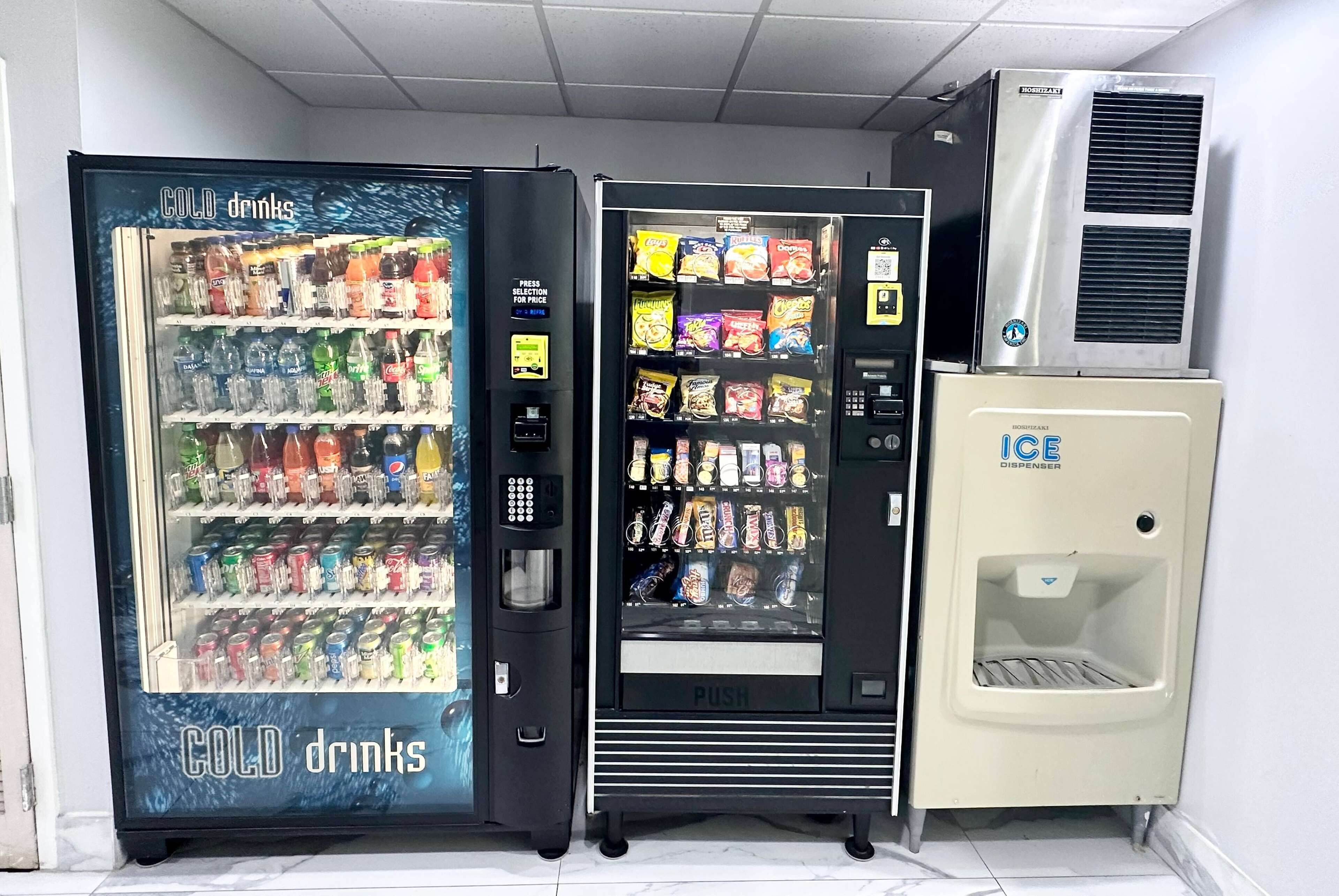 Et automatområde med en coladrik-automat, en snackautomat og isterningsdispenser.