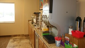 A self-service beverage station with multiple dispensers, a coffee machine, and a variety of condiments and utensils on the counter. - Buffalo Inn (Buffalo)
