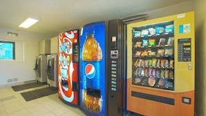 Un área de máquinas expendedoras con refrescos Pepsi y Coca-Cola, y otra máquina con aperitivos.