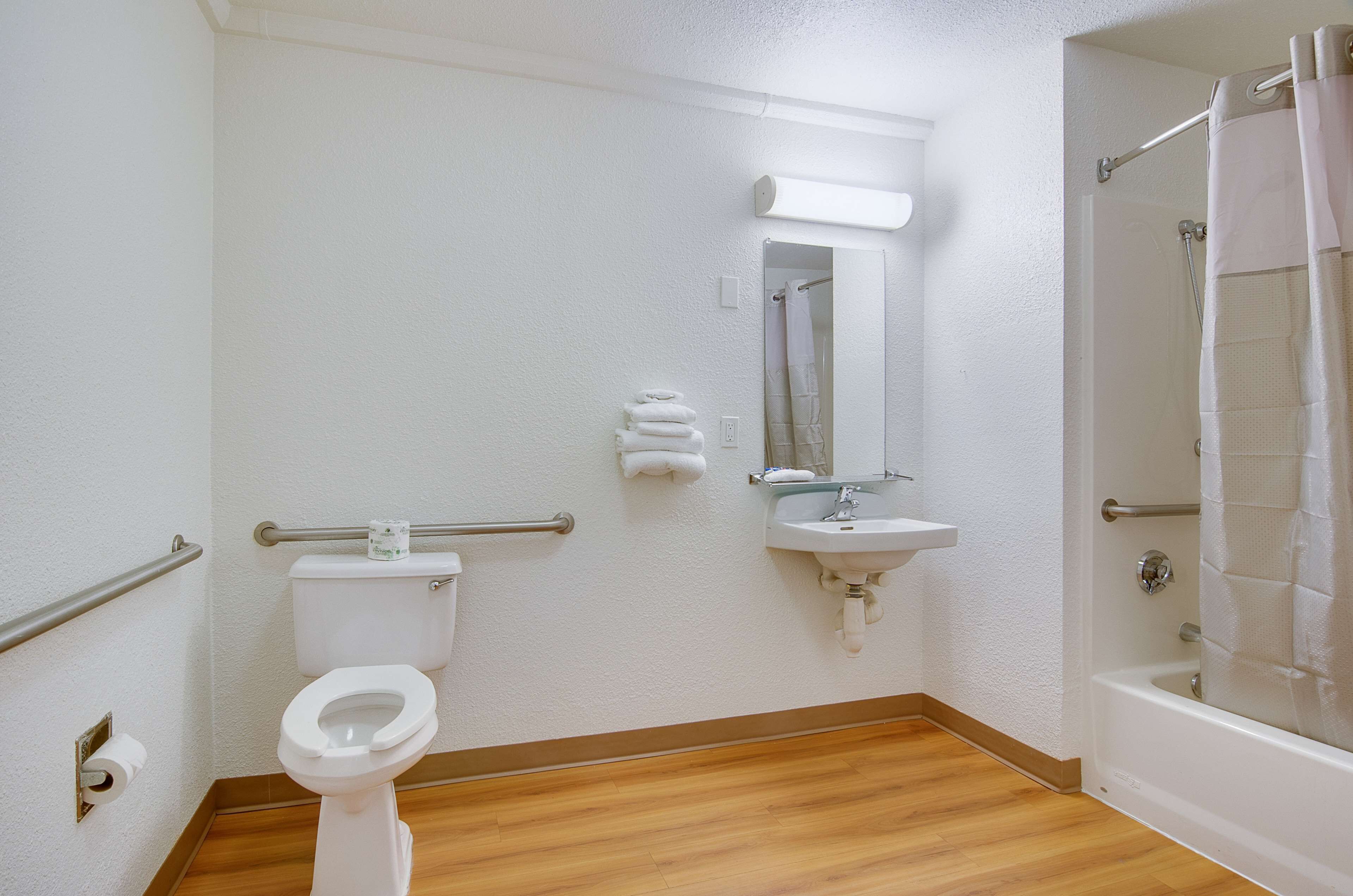 A bathroom with a toilet, sink, and shower.