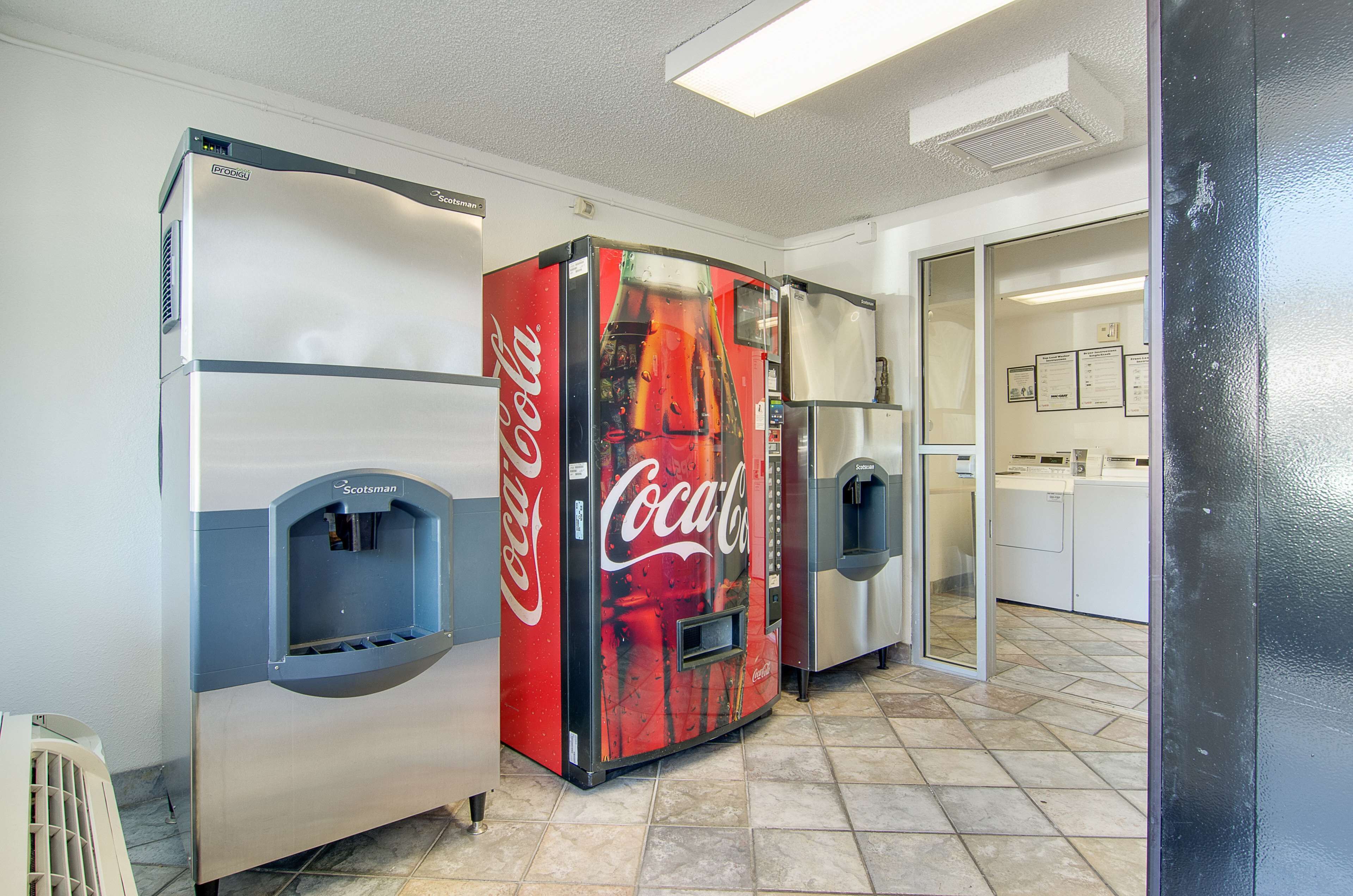 A vending machine area with a Coca-Cola branded machine and a water dispenser.