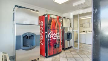 A vending machine area with a Coca-Cola branded machine and a water dispenser.