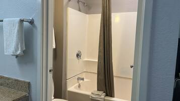 Ein Badezimmer mit Toilette, Badewanne und Duschvorhang.