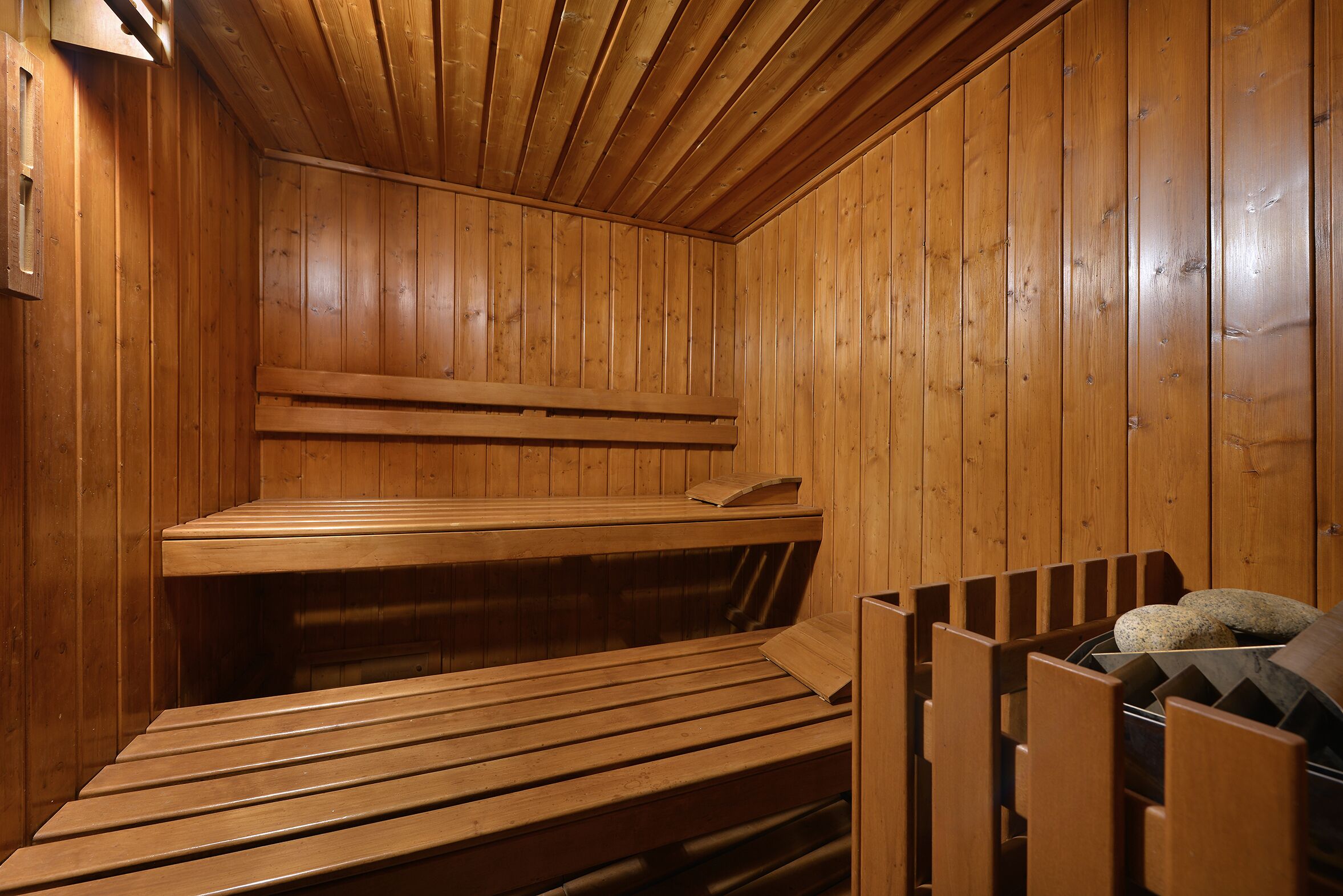 A wooden sauna with benches and a bench seat.
