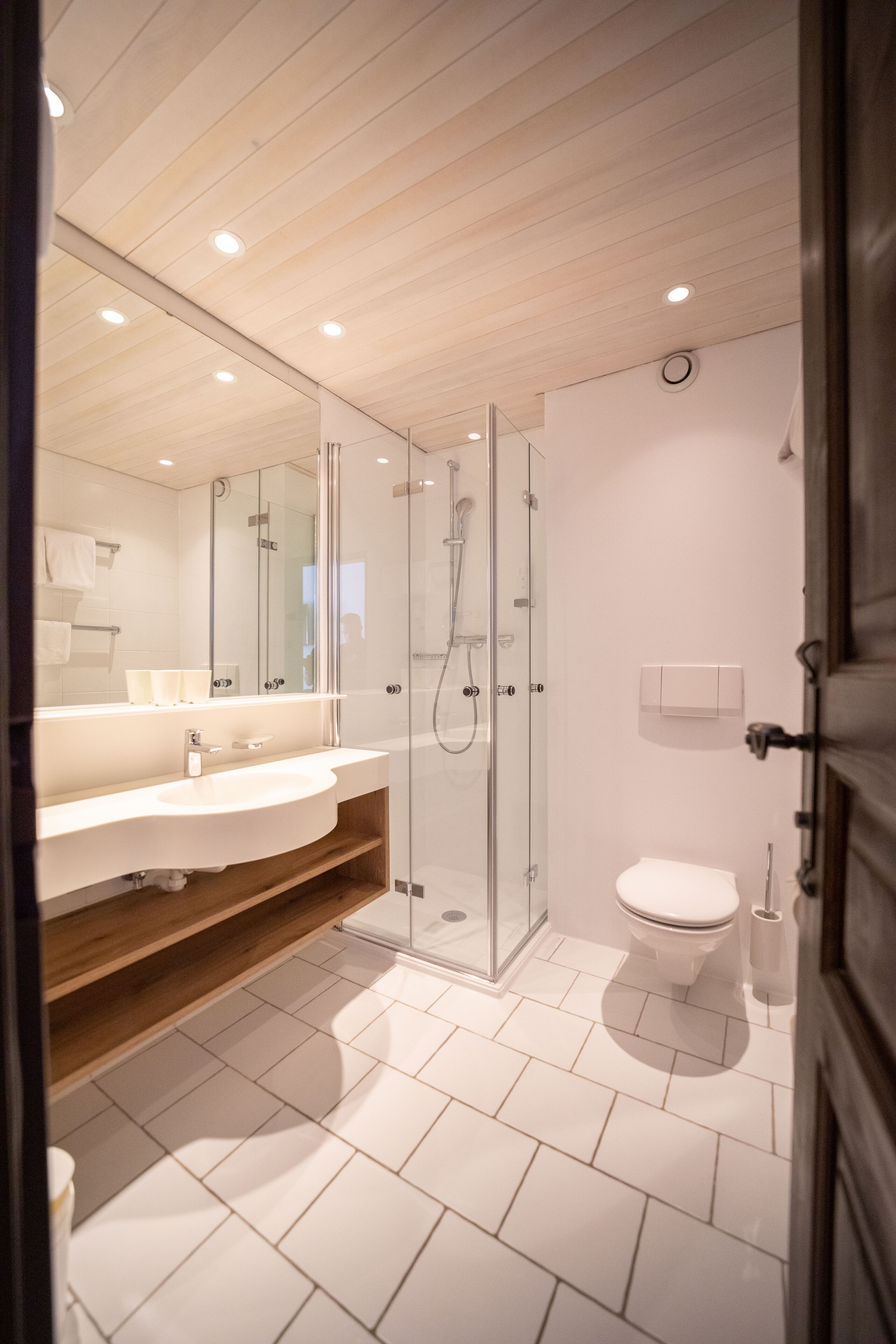 shower, hair dryer, slippers, towels