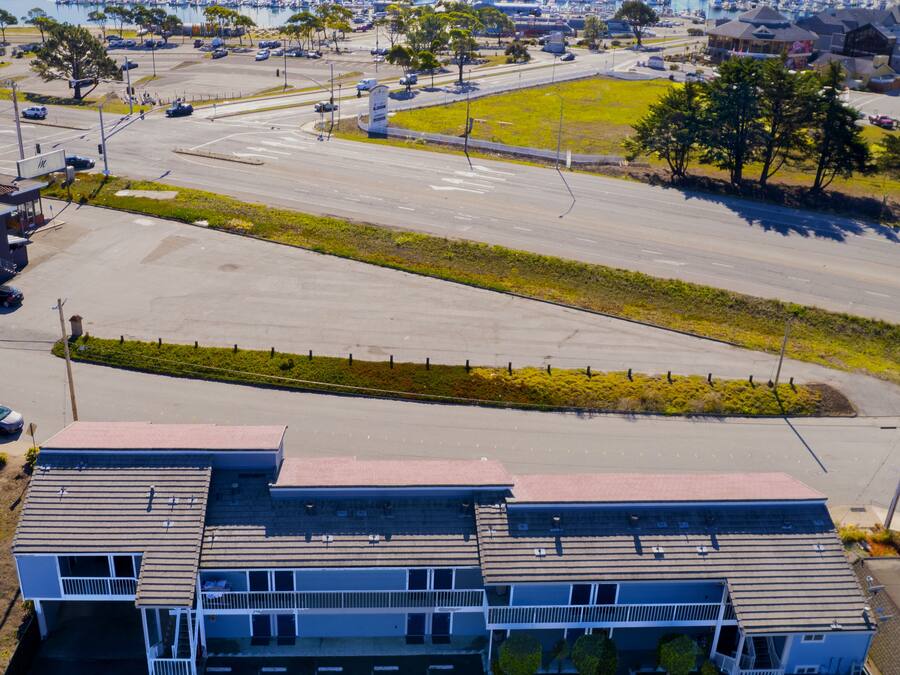 A large parking lot with a marina in the background.