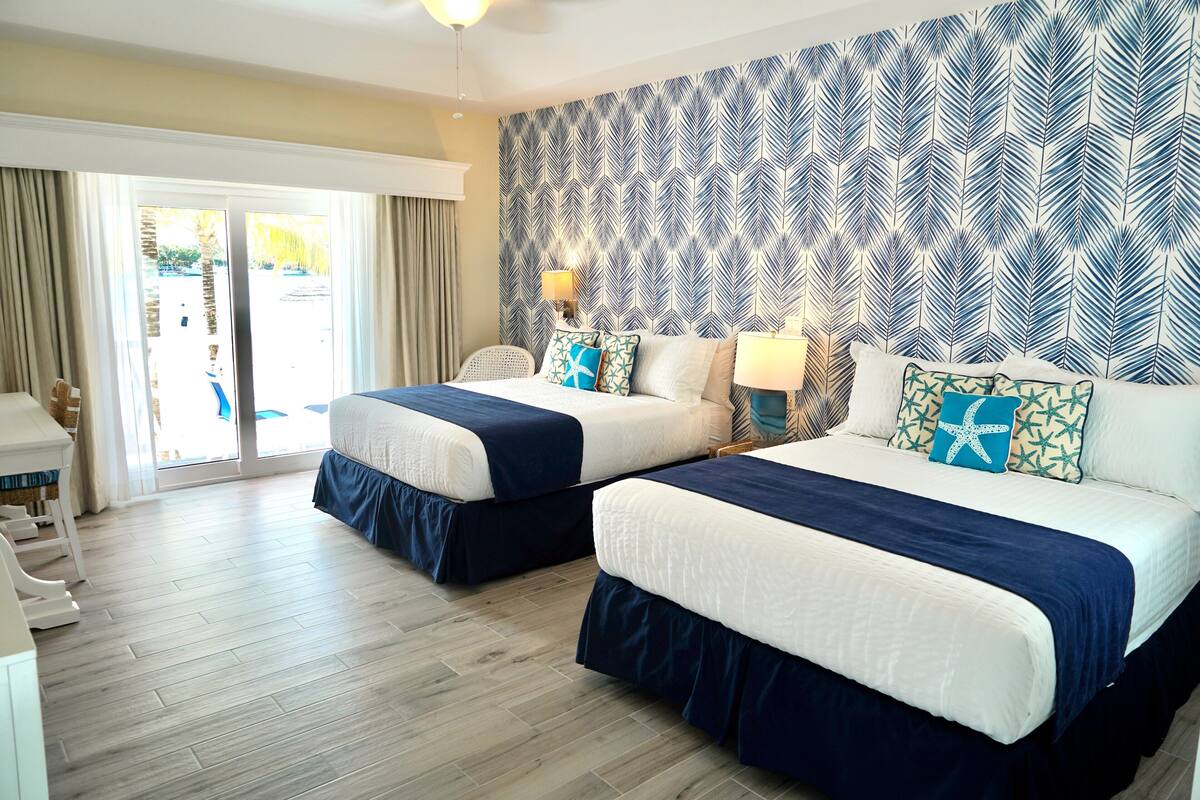 deluxe room, 2 queen beds, lagoon view | 1 bedroom, in-room safe, individually decorated, laptop workspace