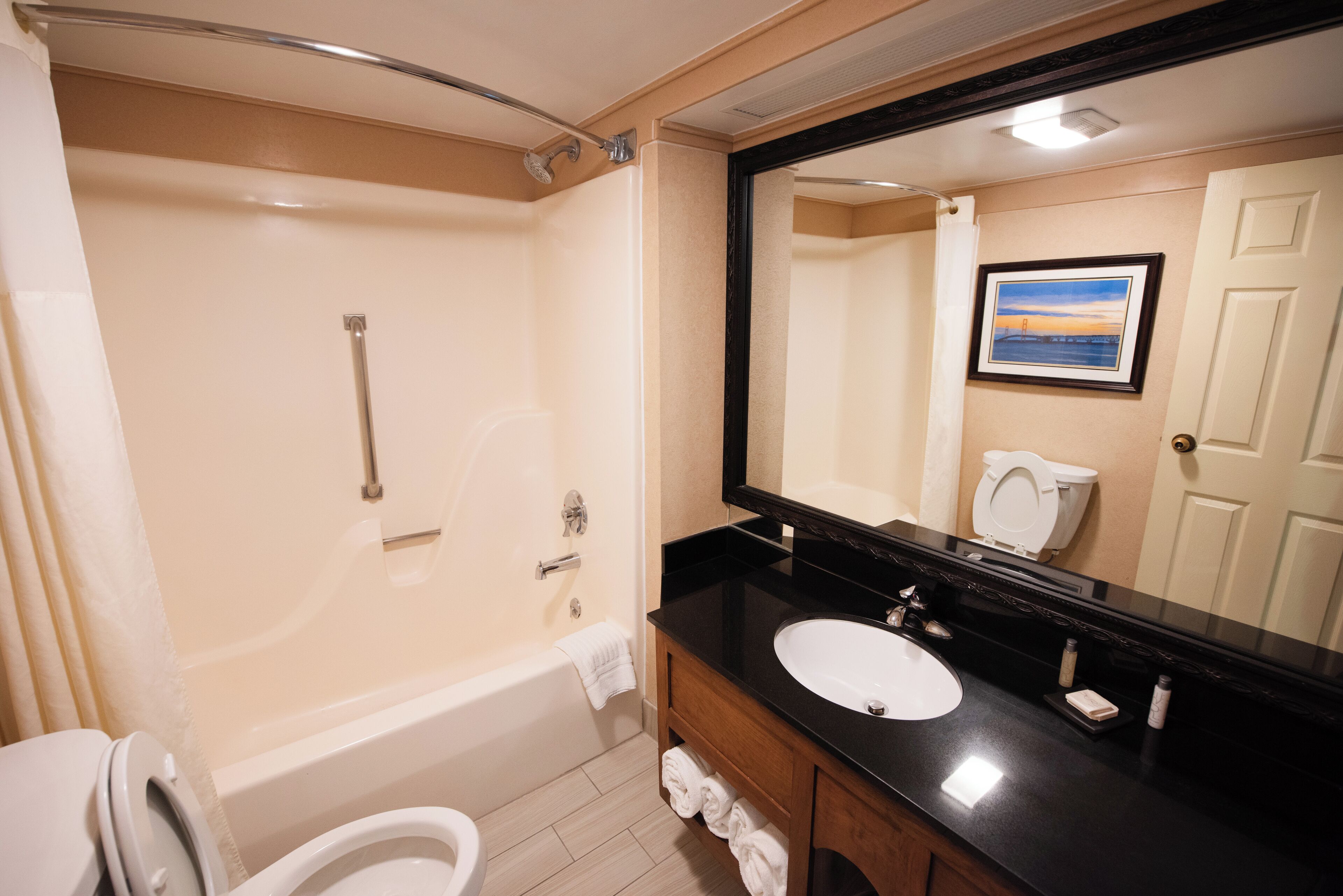 A bathroom with a bathtub, toilet, and sink.