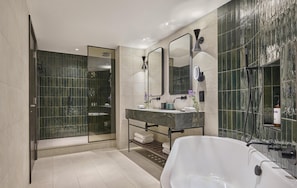 A modern bathroom with a glass-enclosed shower, a marble sink, and a freestanding bathtub. - Hyatt Regency London Blackfriars (London)