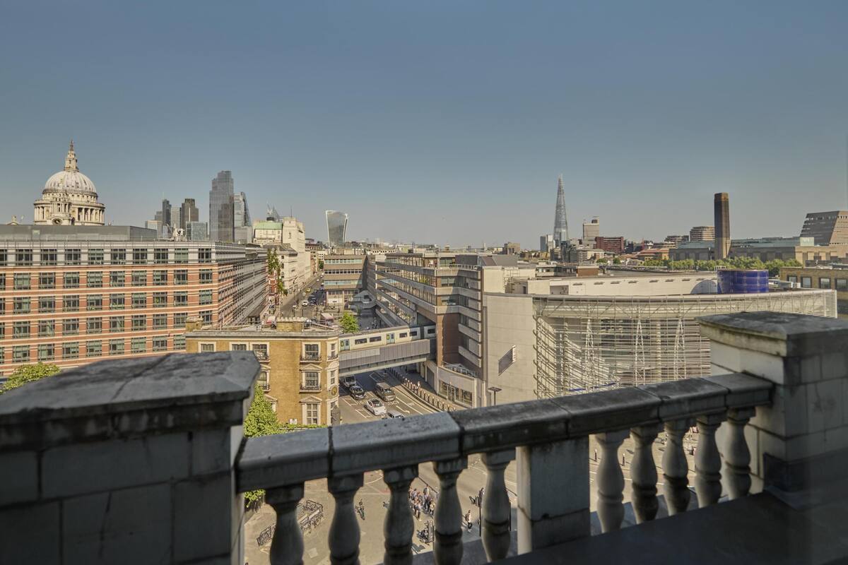 Un paysage urbain présentant une variété de bâtiments, dont une imposante structure en forme de dôme et des gratte-ciel modernes.
