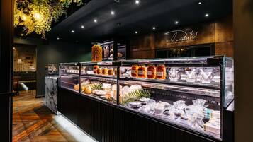 A bakery display with various baked goods and pastries.