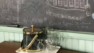 A chalkboard with handwritten notes and a drawing of a house.