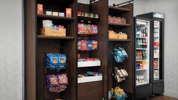 A self-service snack and beverage kiosk with various snack options and drinks.