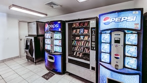 A row of vending machines with a Pepsi logo, including a refrigerator and a drink dispenser. - Motel 6 Niantic, CT - New London (Niantic)