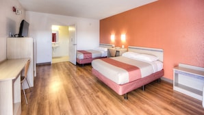 A hotel room with two beds, a desk, and a TV. - Motel 6 Niantic, CT - New London (Niantic)