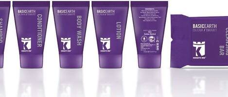 A row of five purple tubes labeled with different skincare products from the brand 'BASICEARTH'.