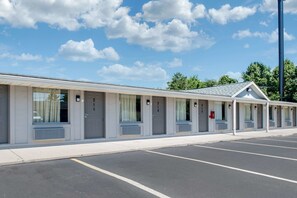 A motel with a row of rooms, each with a number on the door.