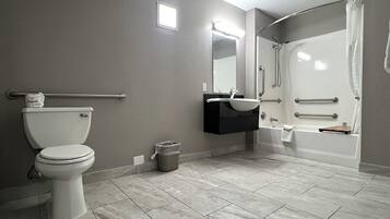 A bathroom with a toilet, sink, and bathtub.