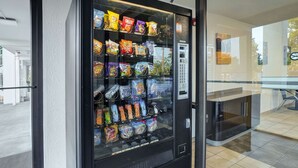 A vending machine stocked with snacks and beverages. - Motel 6 Lexington I-75 Hamburg (Lexington)