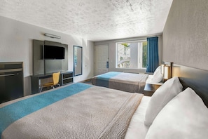 A hotel room with two beds, a TV, a desk, and a window with curtains. - Motel 6 Lexington I-75 Hamburg (Lexington)