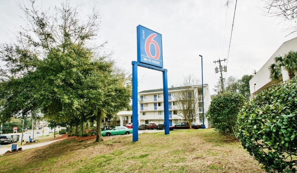 A motel sign with a number 6 and 'WiFi Here' indicating the availability of internet services.