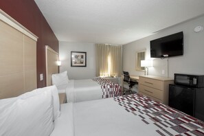 A hotel room with two beds, a desk, a chair, a TV, a microwave, and a picture on the wall. - Red Roof Inn Raleigh North-Crabtree Mall/Lenovo Center (Raleigh)