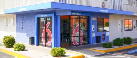 Un motel con fachada azul y un letrero que dice 'Welcome'.