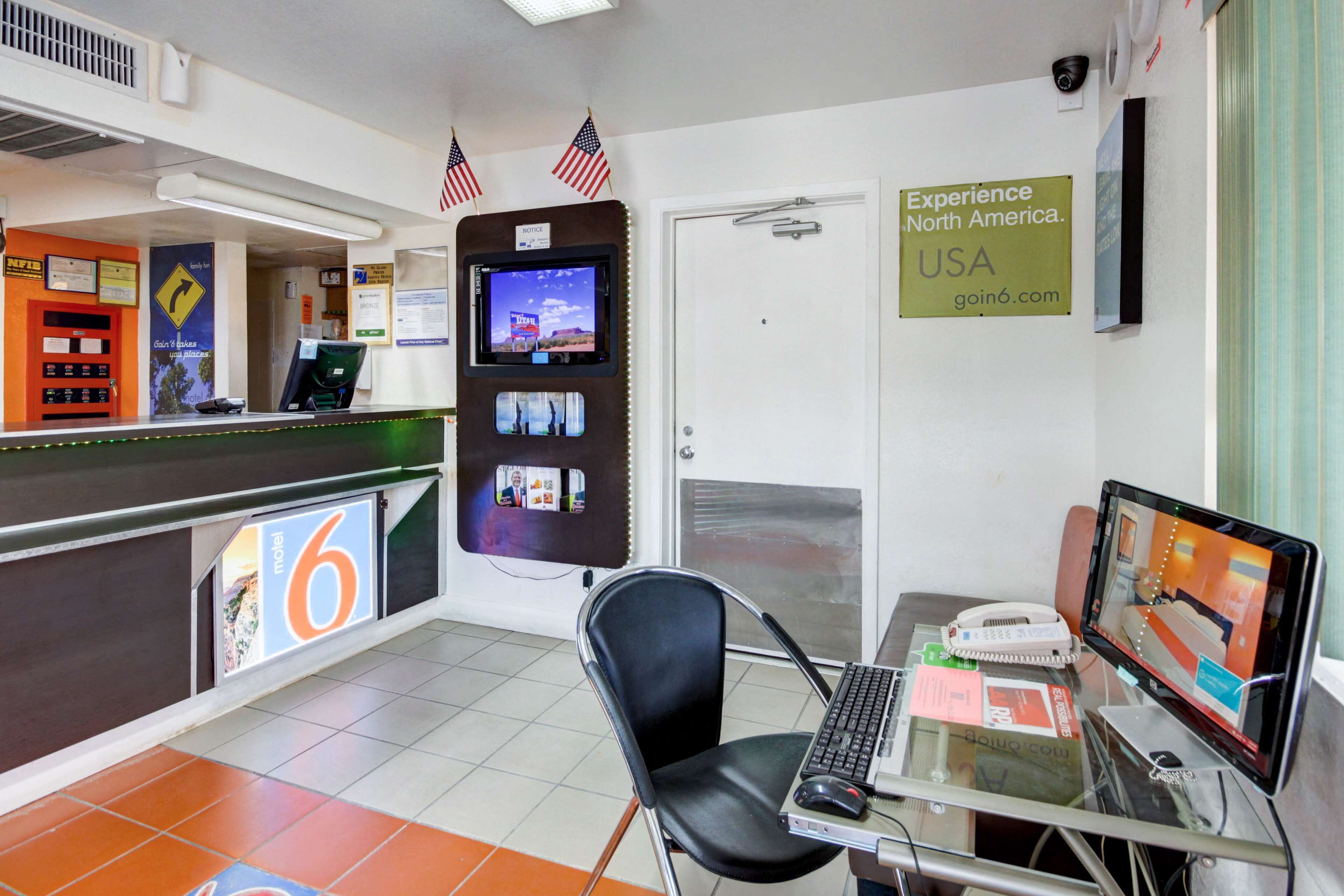 A reception area with a desk, computer, and a sign promoting the USA.