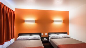 A hotel room with two beds, orange walls, and bedside lamps. - Motel 6 Oroville, CA (Oroville)