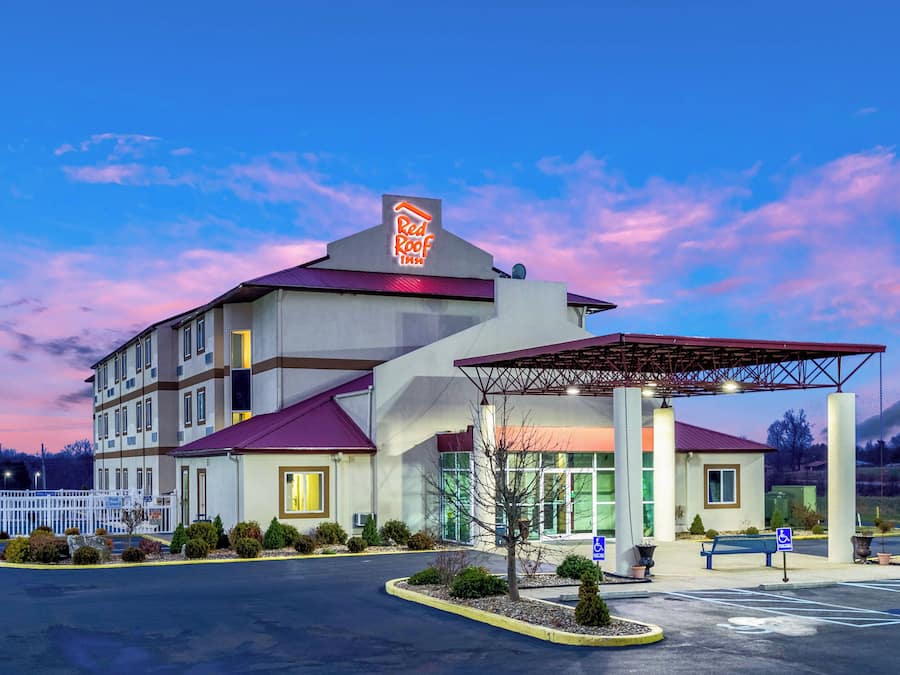 A Red Roof Inn with a covered parking area and a pool sign indicating it is closed.